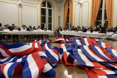 Séance d'installation du premier CME. Des écharpes tricolores posées sur la table au premier plan